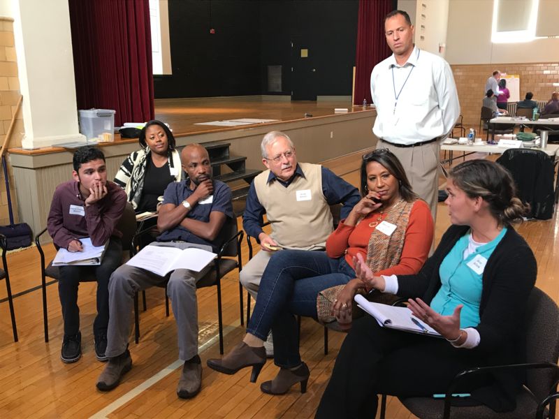 seven committee members discuss in a small group