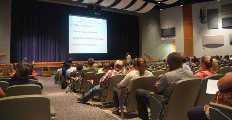 members of the public attend a strategic planning presentation in the HHS auditorium