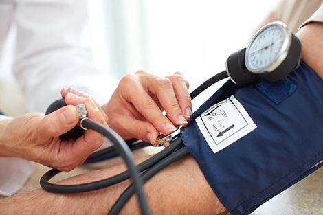 Dr taking patient blood pressure